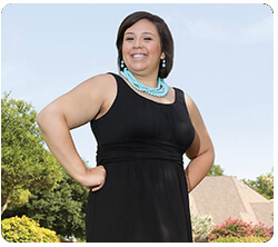 A well-dressed woman stands proudly